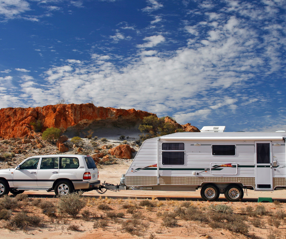  4WD and a caravan in the outback and a blue sky