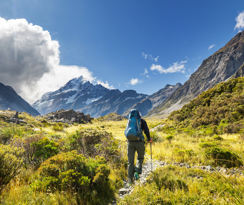 man with blue camping bag and hiking in the mountains 